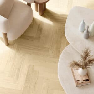Parkwood Herringbone Nude real oak flooring with an armchair and round coffee tables