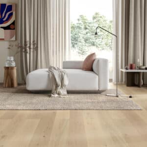 Parkwood XL Nude real oak flooring in a living room with a white sofa and rug